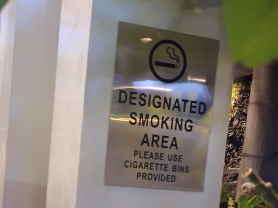 A sign identifying a Designated Smoking Area in India