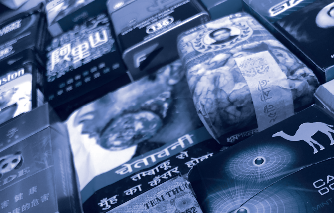 various cigarette packs with health warning labels.