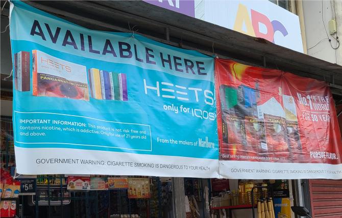 HTP and cigarette banner ads displayed outside a retail location in Metro Manila