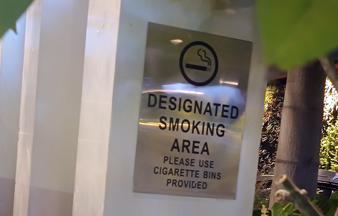 A sign identifying a Designated Smoking Area in India